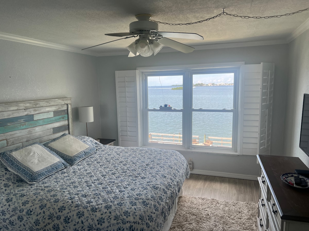 Bedroom with king bed and waterfront view